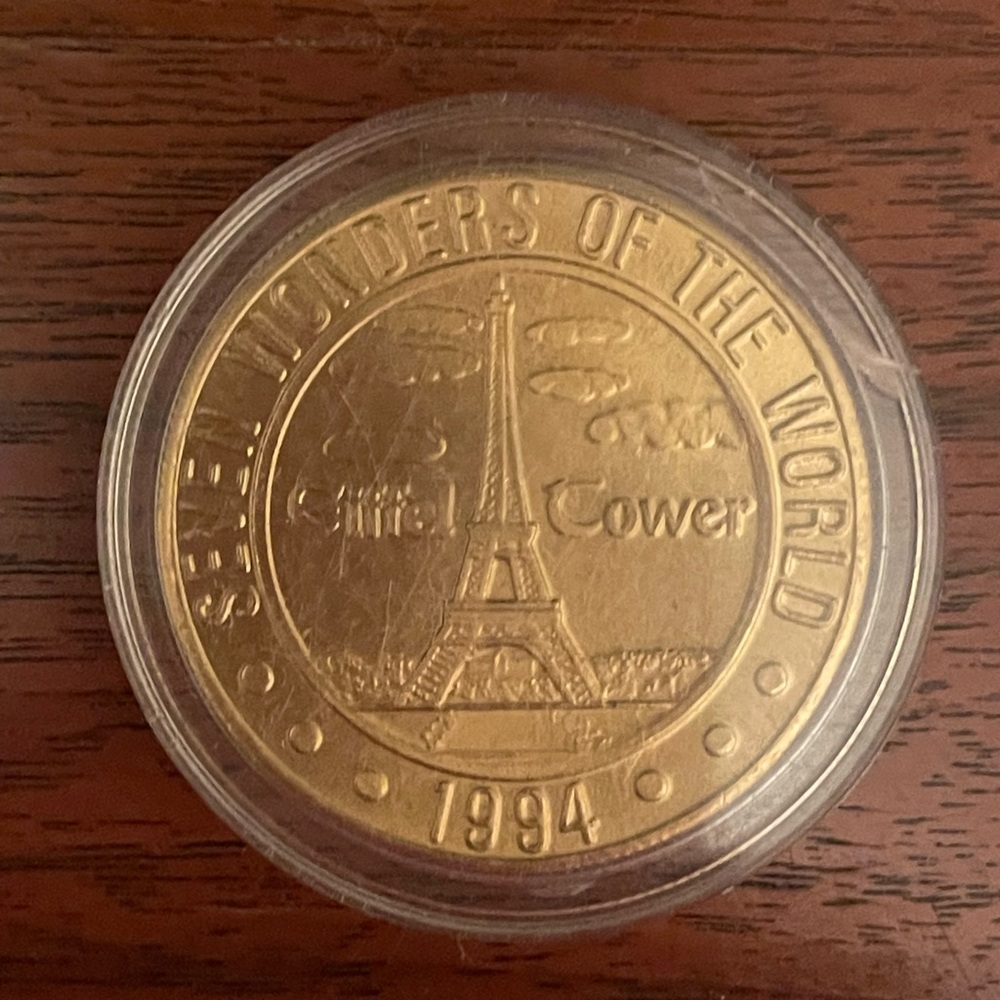 1994 GRAND CASINO (BILOXI, MS) SEVEN WONDERS EIFFEL TOWER GOLD GAMING TOKEN